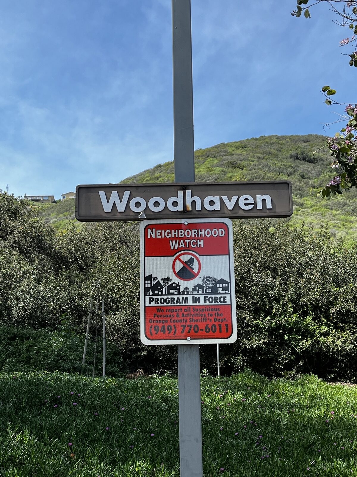 Reflective neighborhood watch sign installed in a Woodhaven residential community